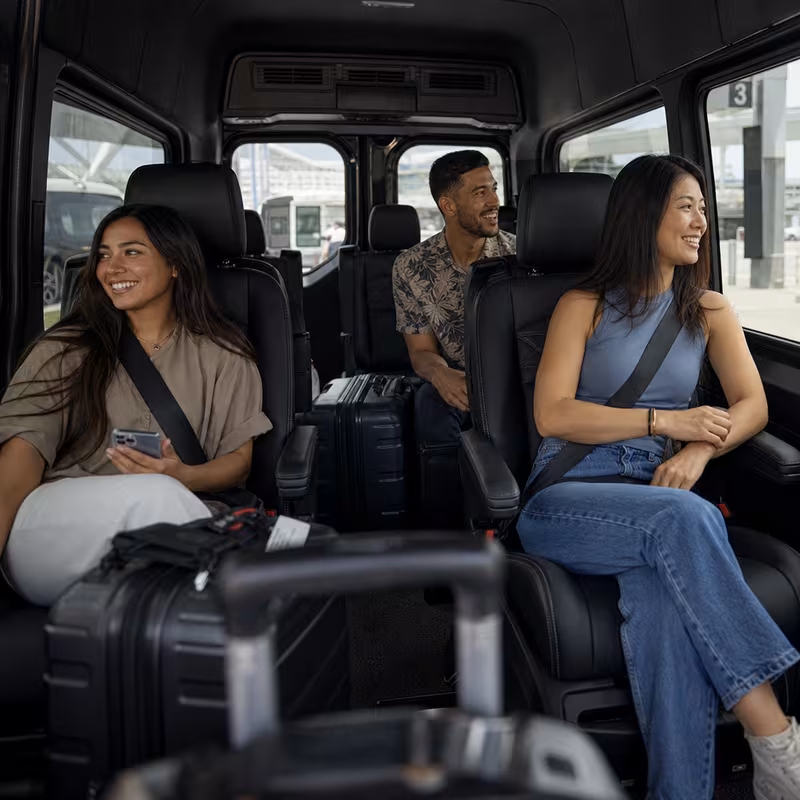 Passengers loading luggage while boarding an Omaha group shuttle