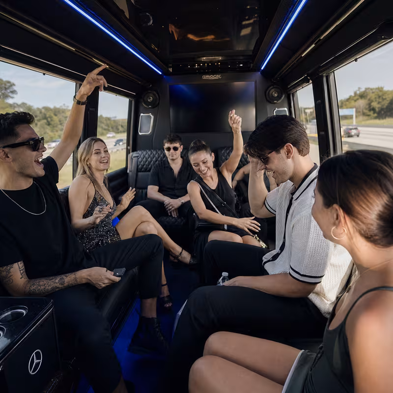 Group boarding a white charter bus for Concert Transportation transportation in Omaha