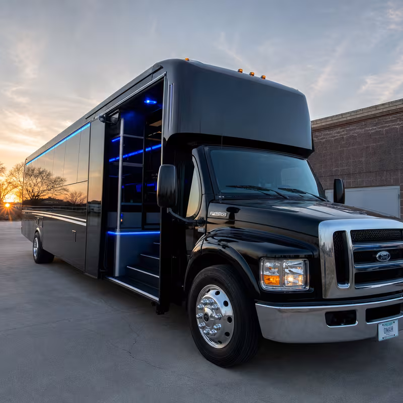 Party bus interior with wraparound leather seating and LED lighting in Omaha