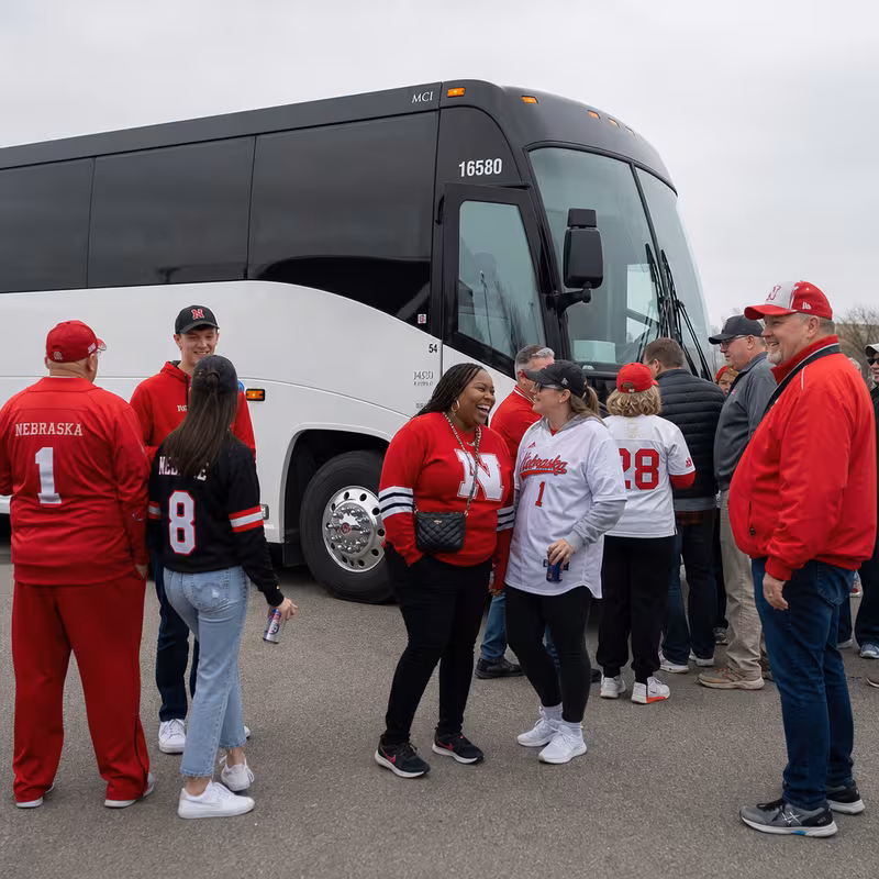 Passengers loading luggage while boarding an Omaha group shuttle