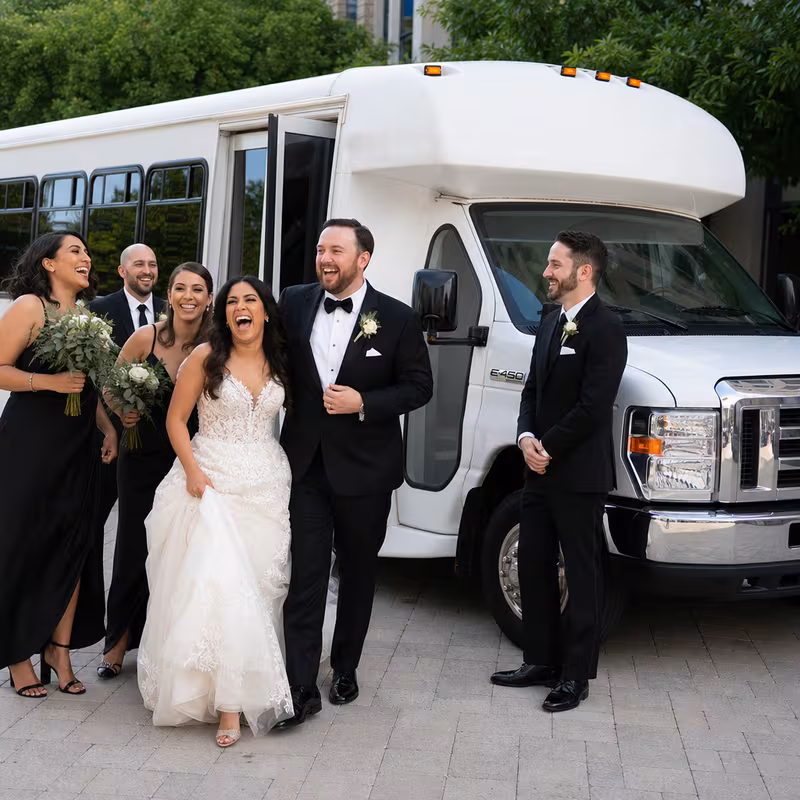 Passengers loading luggage while boarding an Omaha group shuttle