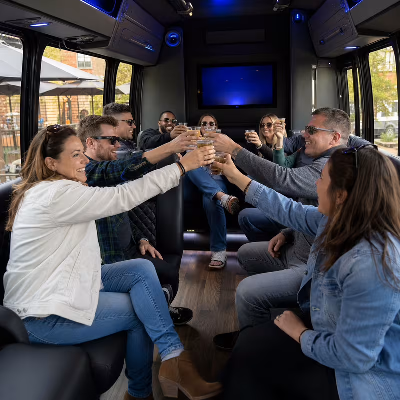 Group boarding a white charter bus for Winery & Brewery Tour Transportation transportation in Omaha