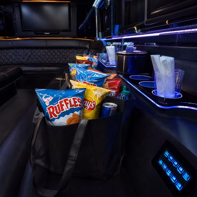 Party bus interior with wraparound leather seating and LED lighting in Omaha